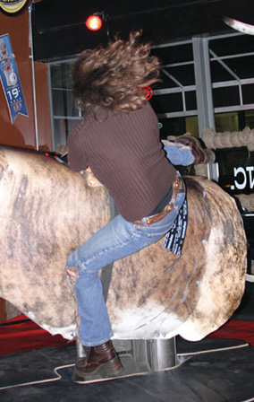 Falling off of the mechanical bull at Cowgirls Inc